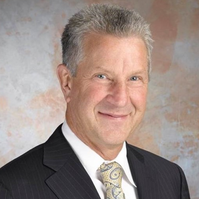 A photo of a man on a gray-ish background