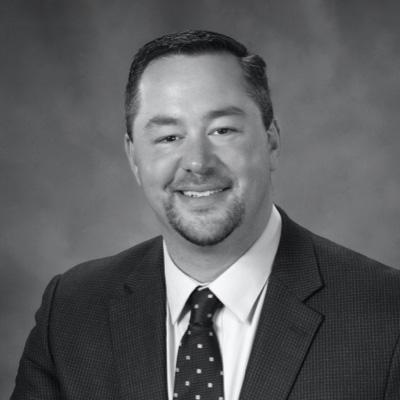 a black & white image of a man in a suit