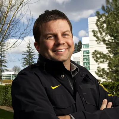 a photo of a man i front of a nature scene