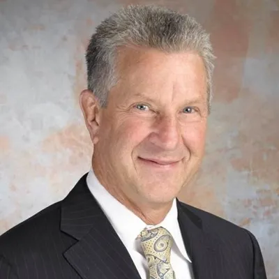 A photo of a man on a gray-ish background