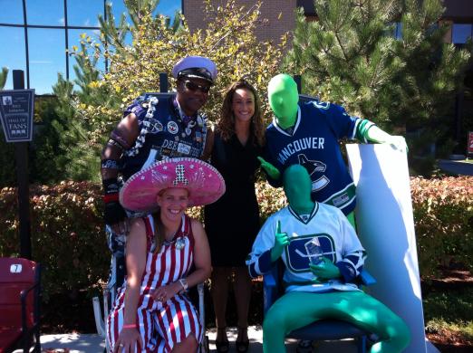 Courtney Carter standing with Hall of Fans inductees