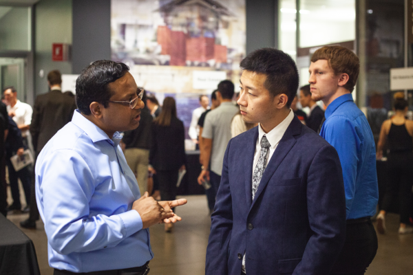 An employer talking with a student at a career fair