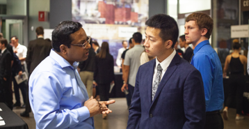 An employer talking with a student at a career fair