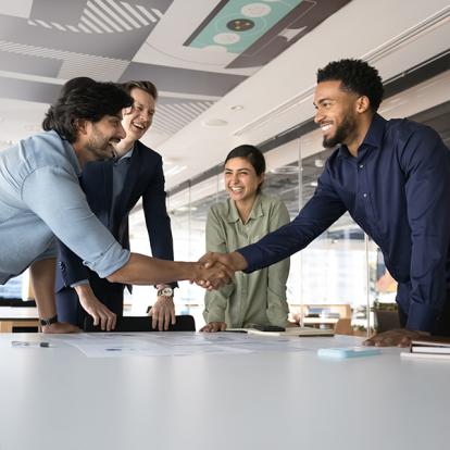 people shaking hands over a table