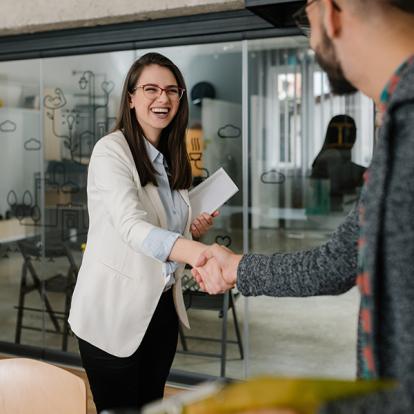 two people shaking hands in a business setting