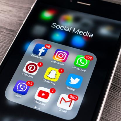 a photo of a phone screen with a folder of social media apps open