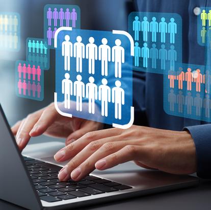 a person working on a laptop as simulations of groups of people pop up with one of them being circled