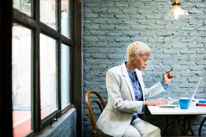 business woman in suit on a laptop in a cafe