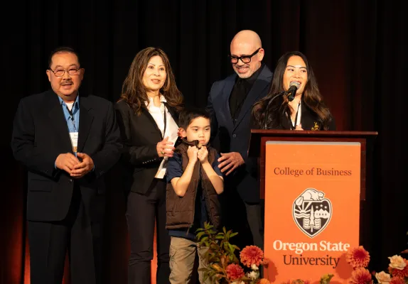 Five members of the Quach family at a podium at the Excellence in Family Business Awards