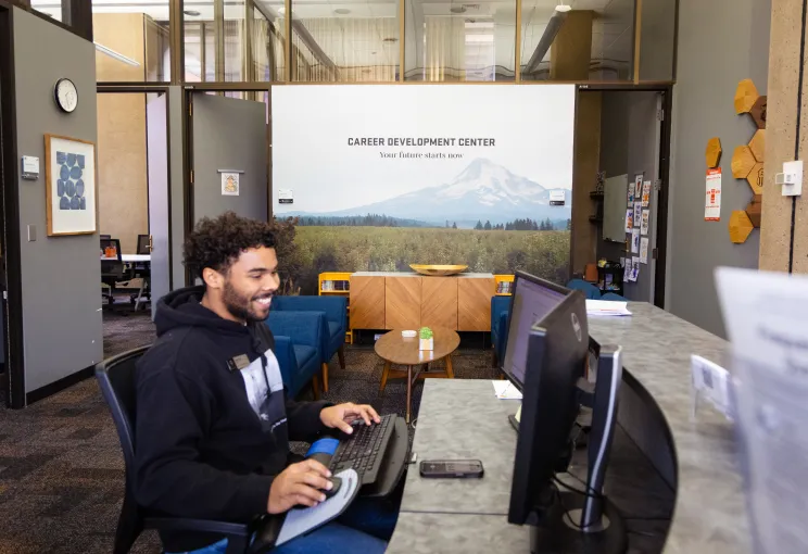A man working on a computer in the Career Development Center